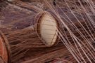 A basket being weaved on a wooden form